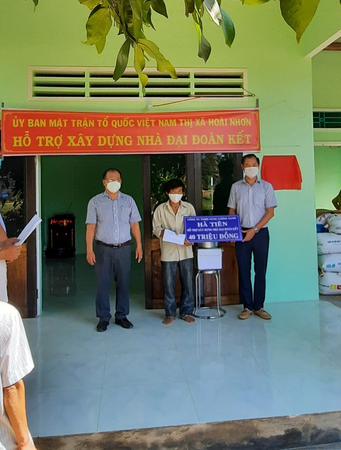 Ông Nguyễn Văn Đẹp – Chủ tịch Mặt trận thị xã và  ông Nguyễn Thanh Phong  – GĐ Công ty TNHH Năng Lượng Xanh Hà Tiên trao tiền hỗ trợ hộ Tạ Quang Thanh